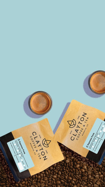 Clayton Coffee packages with coffee beans and cups on a blue background